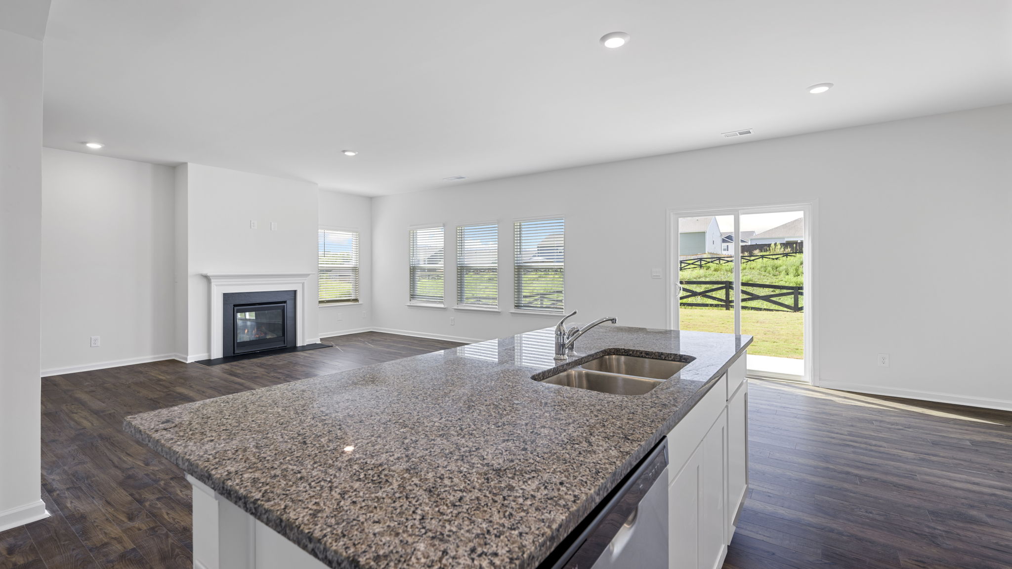 Open concept living, dining, and kitchen space