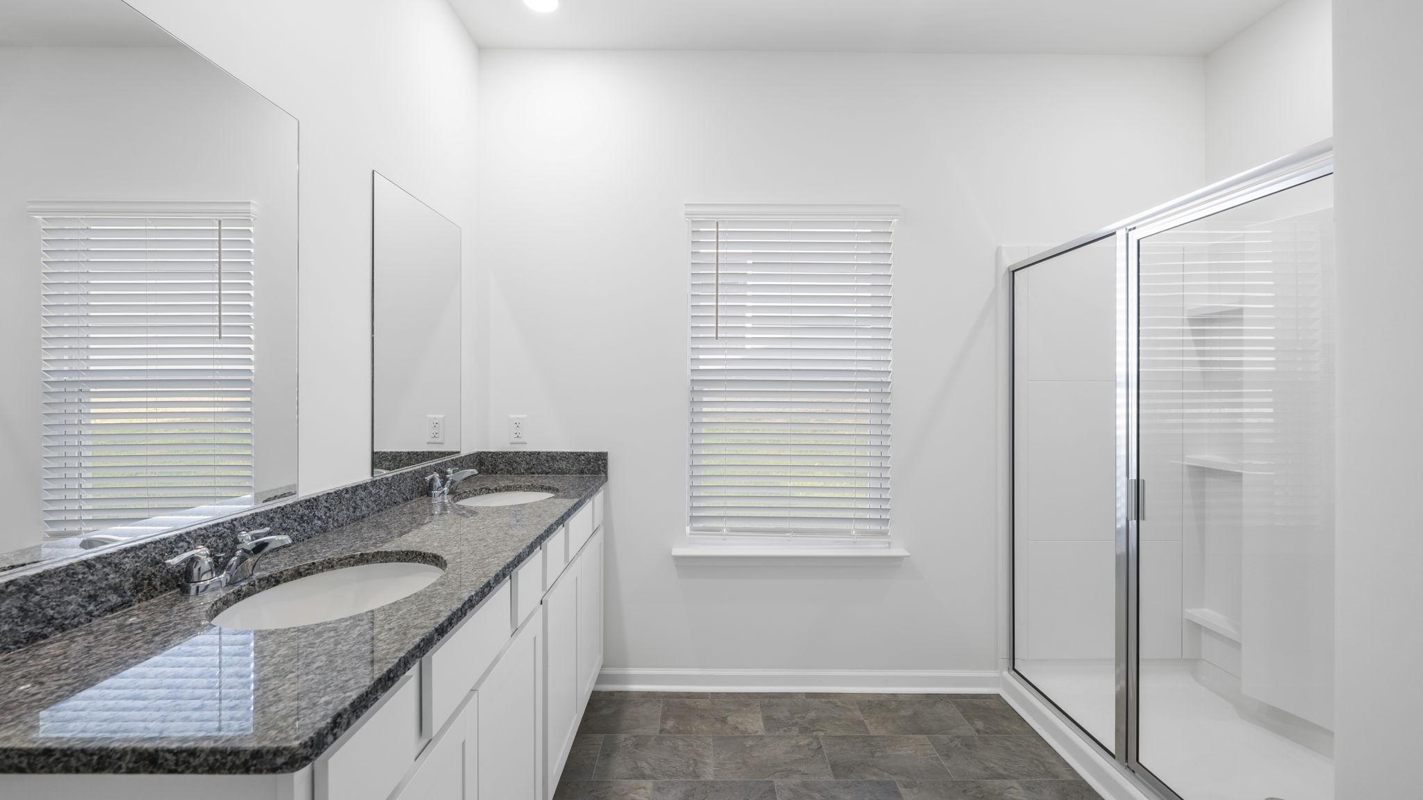 Primary bathroom with double vanity and walk-in shower