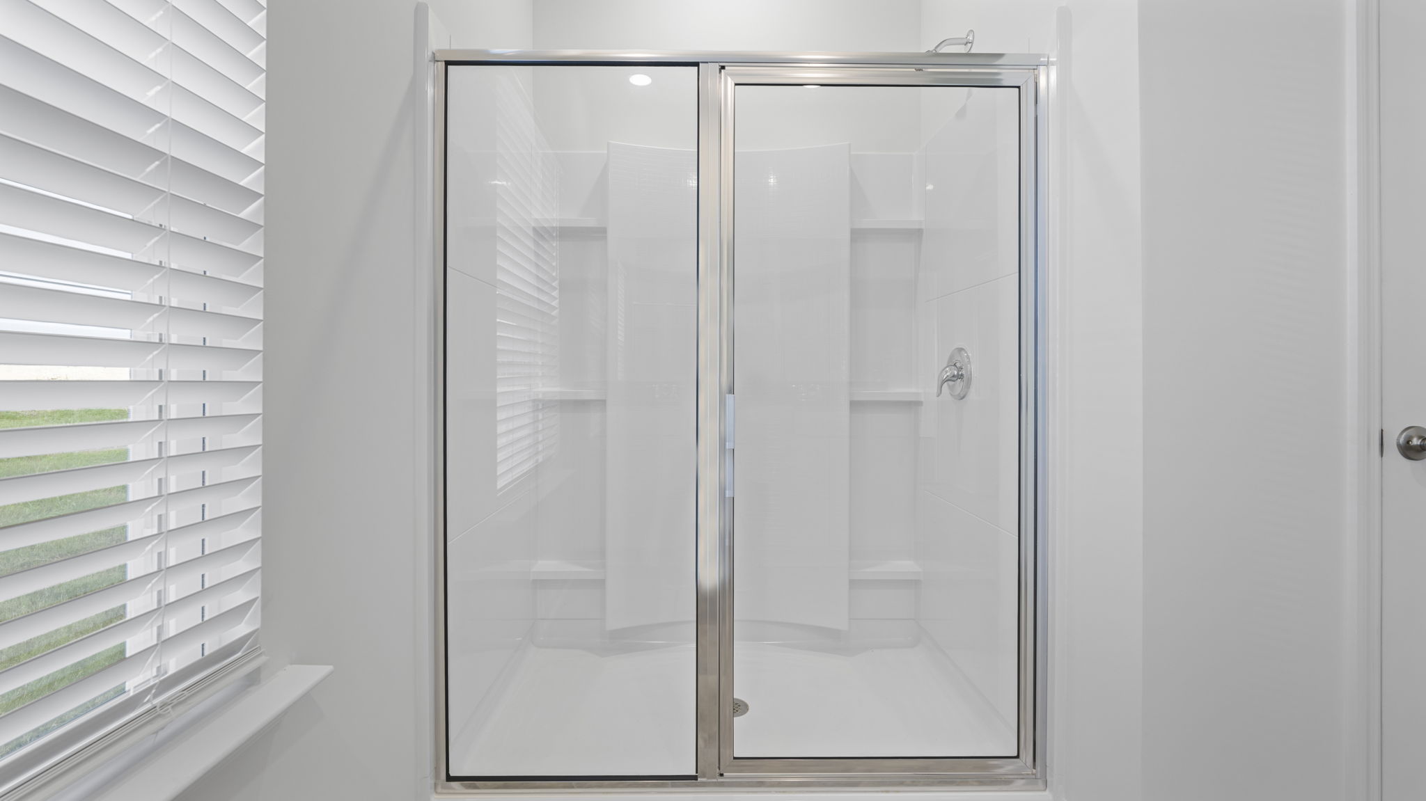 Primary bathroom with double vanity and walk-in shower