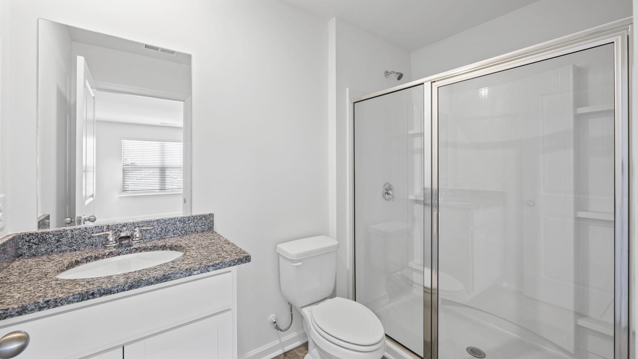 Secondary bedroom suite with ample natural light and carpet floors