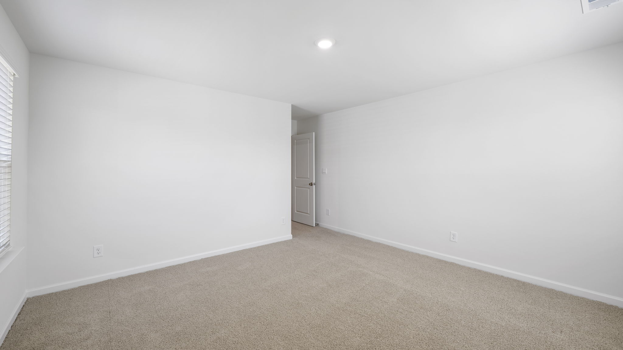 Bedroom with ample natural light and carpet floors