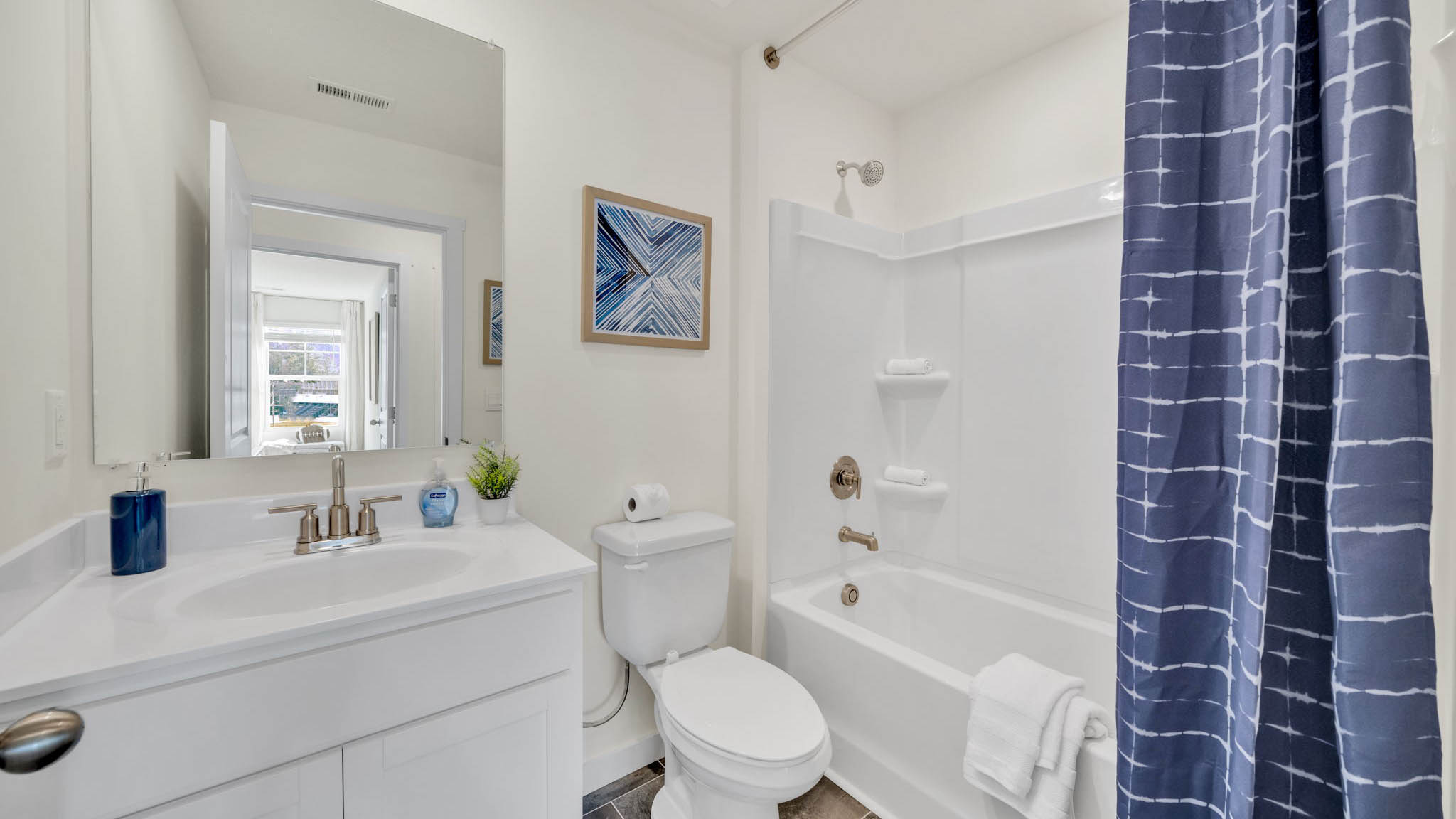 Upstairs guest bathroom with combination shower and bathtub