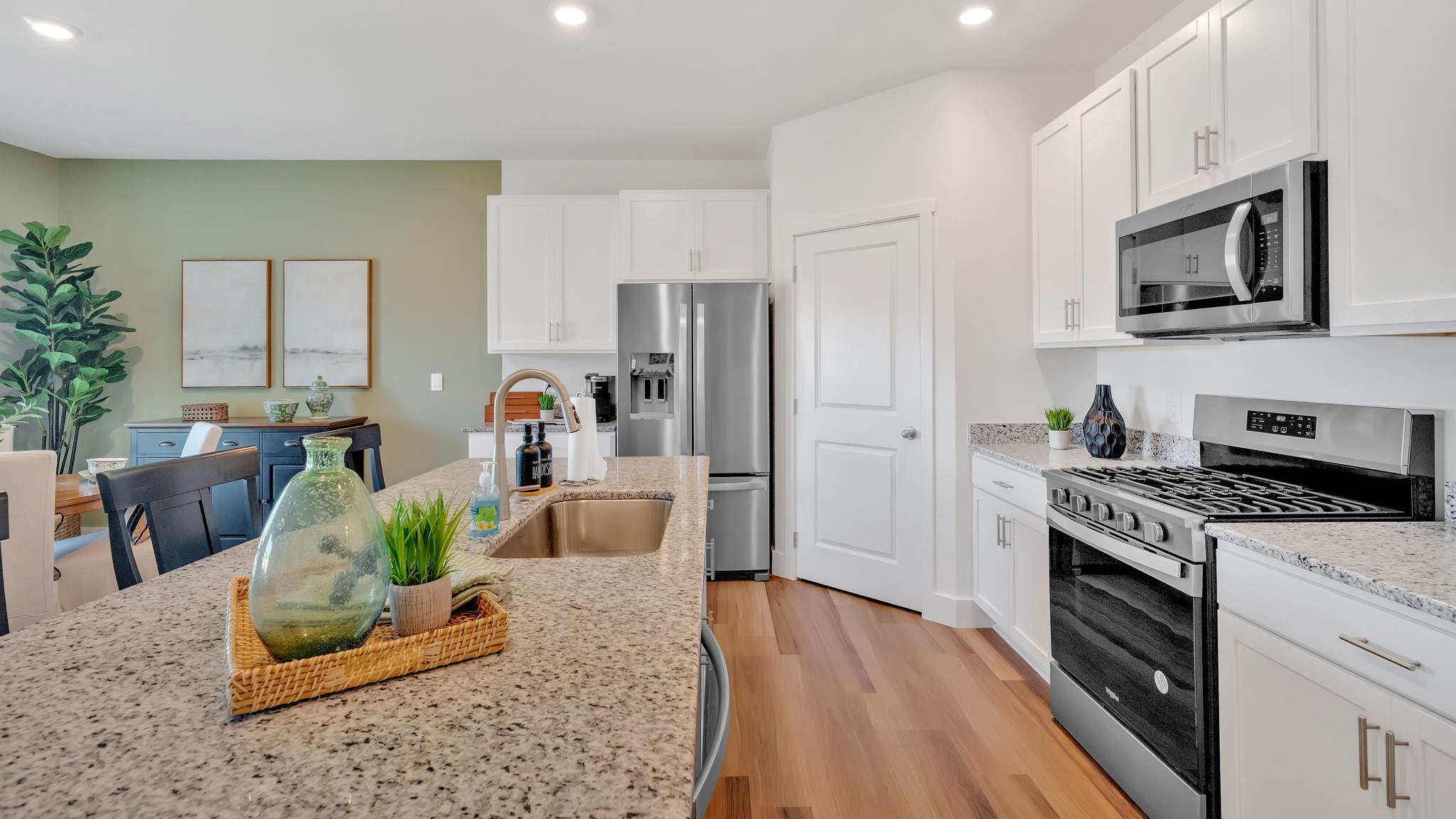 Kitchen with stainless steel appliances, shaker style cabinets, and elevated finishes