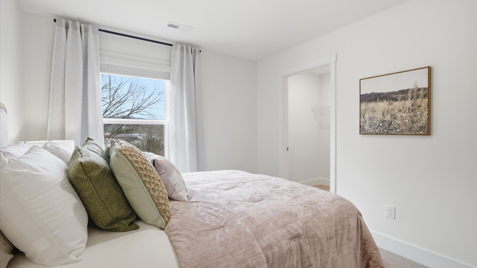 Bedroom with ample natural light and carpet floors