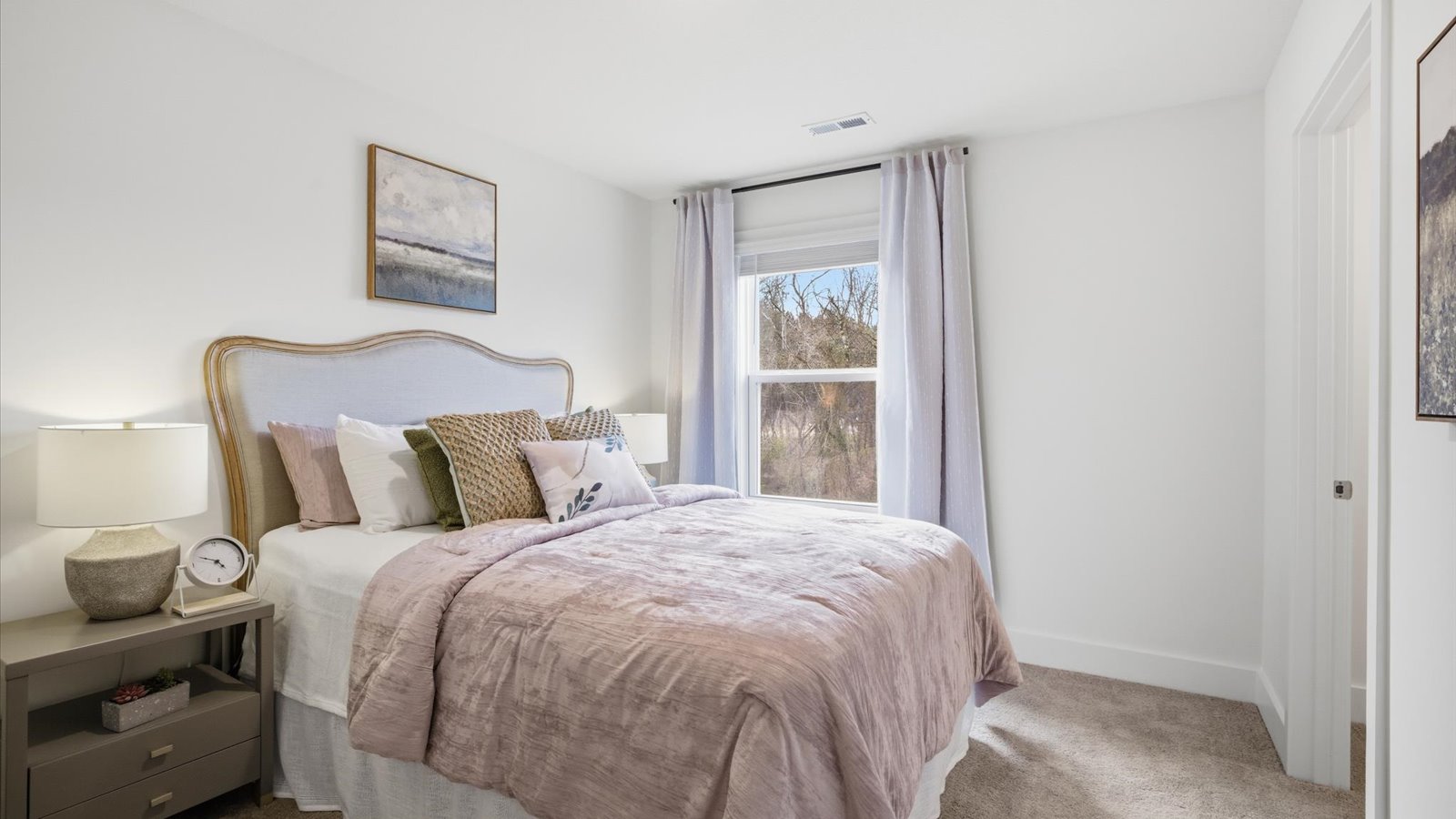 Bedroom with ample natural light and carpet floors