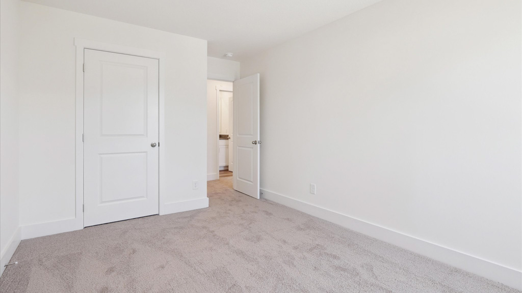Primary bedroom with private attached bathroom and walk-in closet