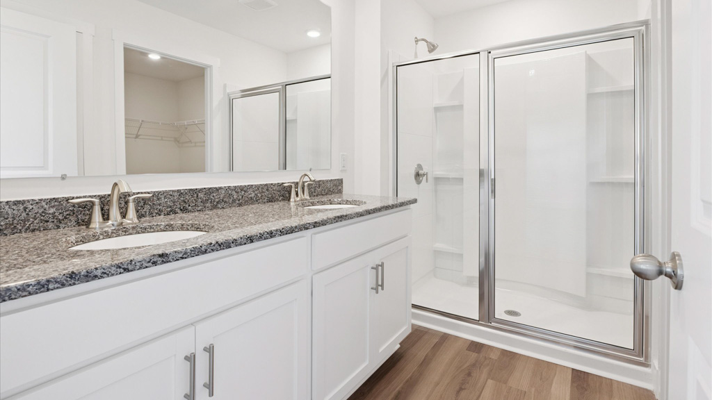 Primary bathroom with double vanity and walk-in shower