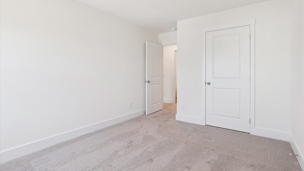 Bedroom with ample natural light and plush carpet floors