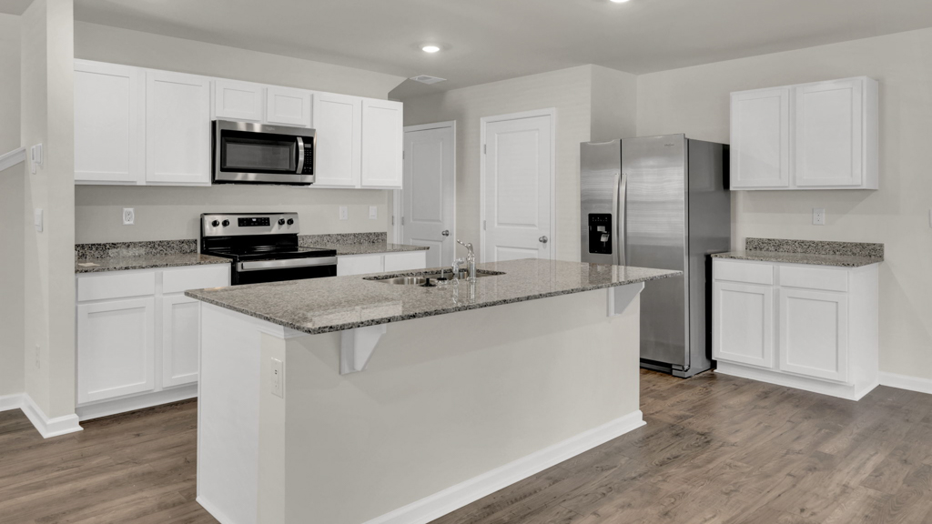 Kitchen with stainless steel appliances, shaker style cabinets, and elevated finishes