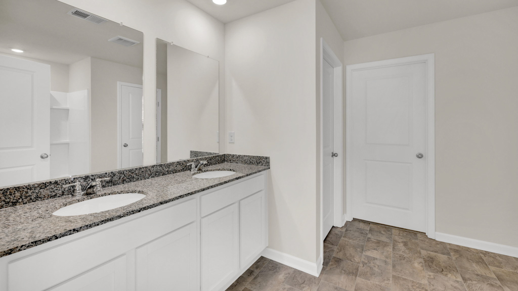 Private attached primary bathroom with built in vanity