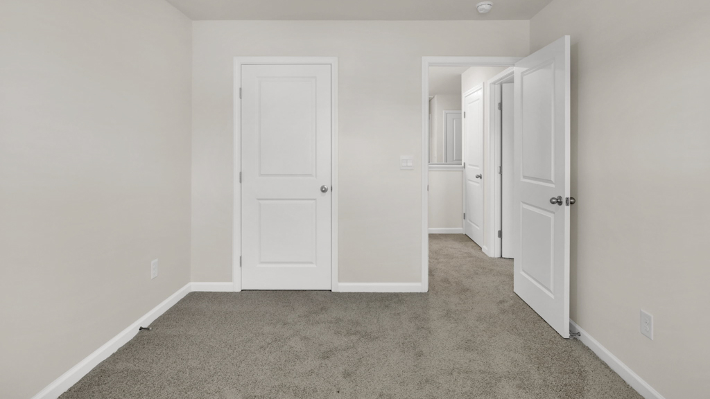 Bedroom with ample natural light and plush carpet floors