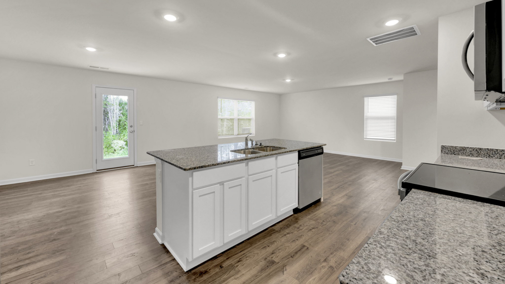 View from dining room to kitchen with island, pantry, new appliances included, cabinets Price's Point