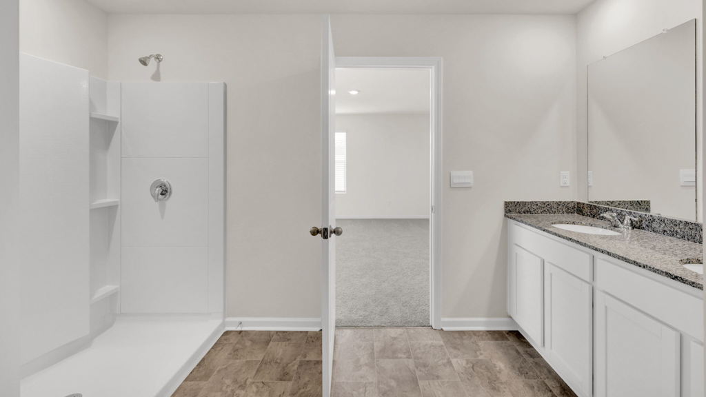Owner’s ensuite in a new build home offers function and style with a walk-in closet, spa-like ensuite