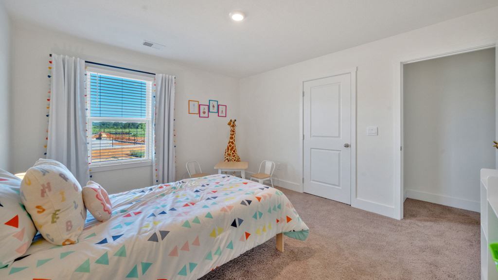 Secondary bedroom showcases space via single door closet, window, convenient home upstairs access Price's Point