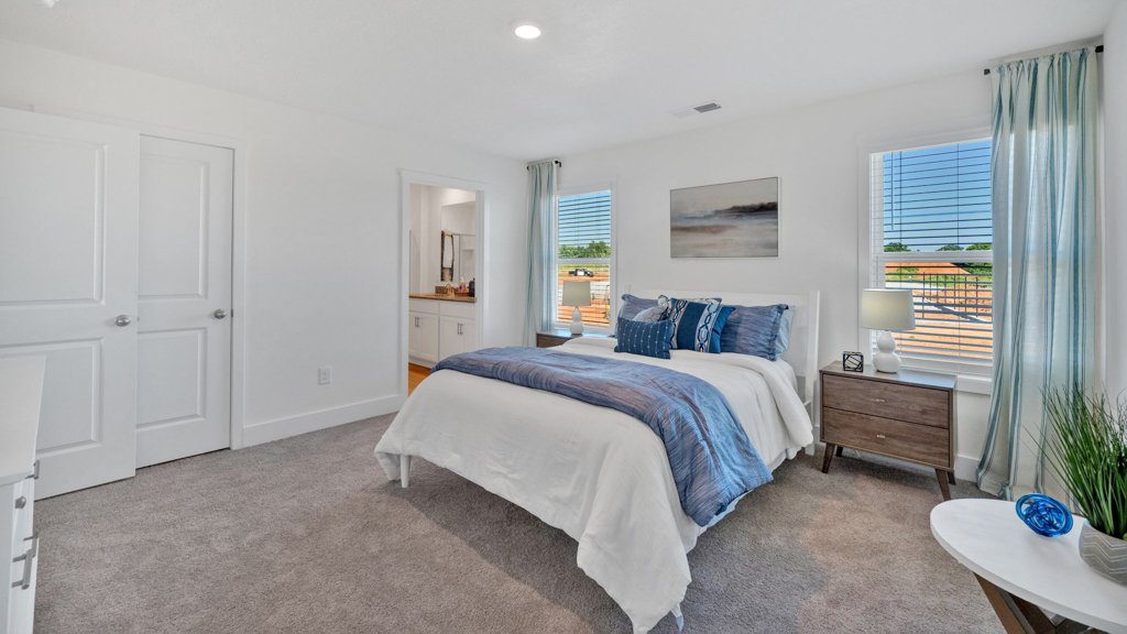 Secondary bedroom in Price's Point showcases quality designs with closet space, soft window light, upstairs connectivity