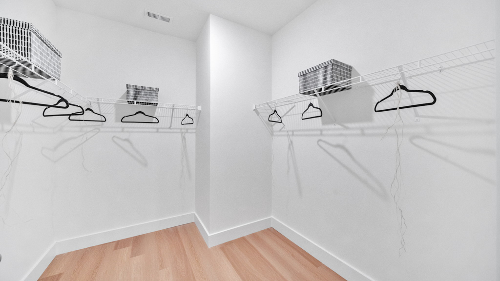 Primary suite walk-in closet in Price's Point new home with built-in shelving and generous storage