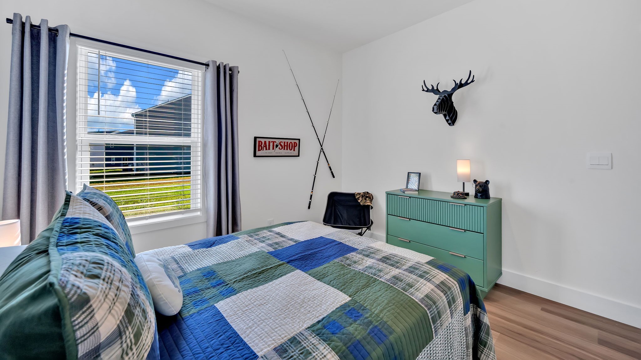 bedroom with large window and LVP flooring