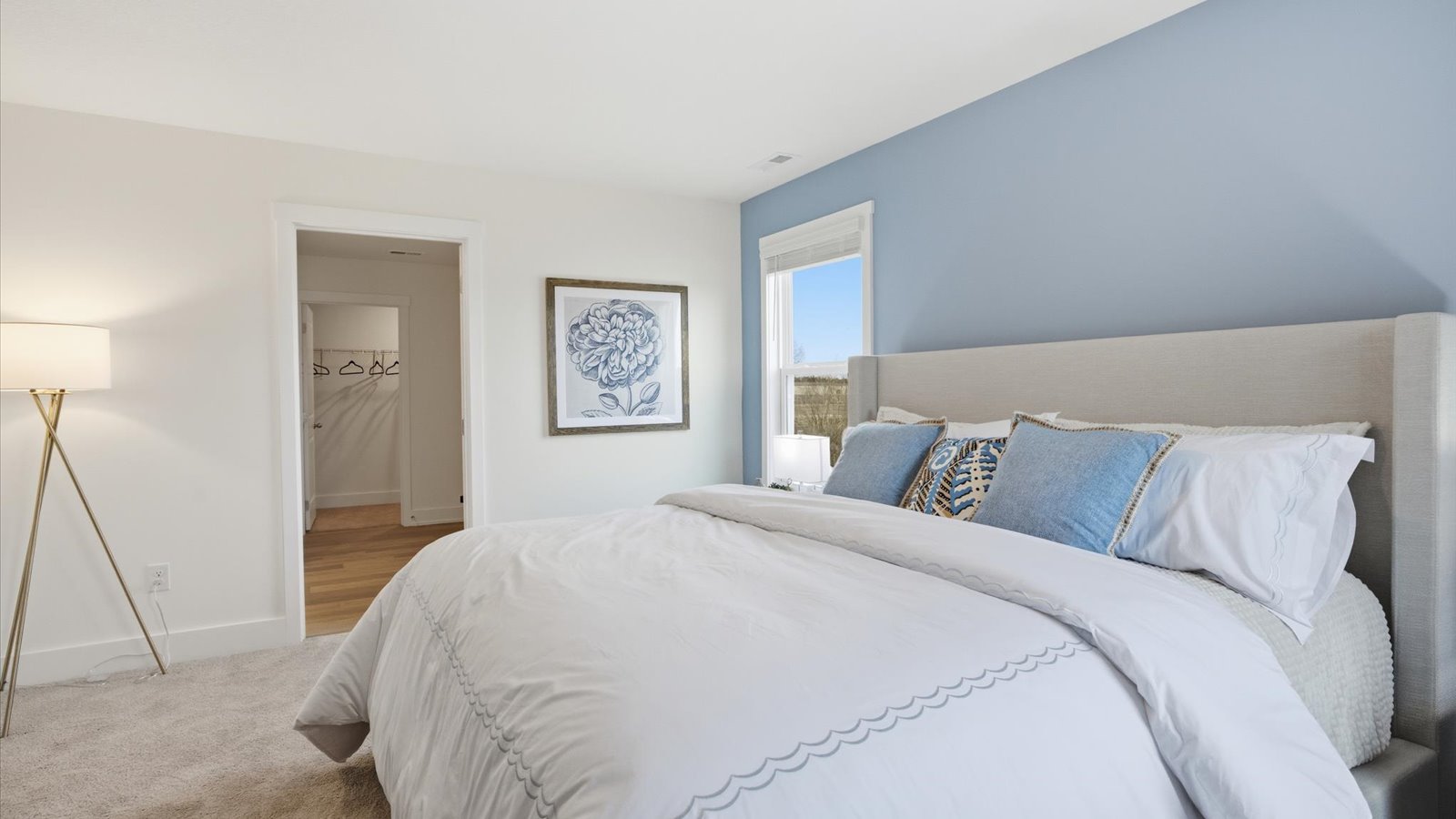 Primary bedroom with private attached bathroom and walk-in closet