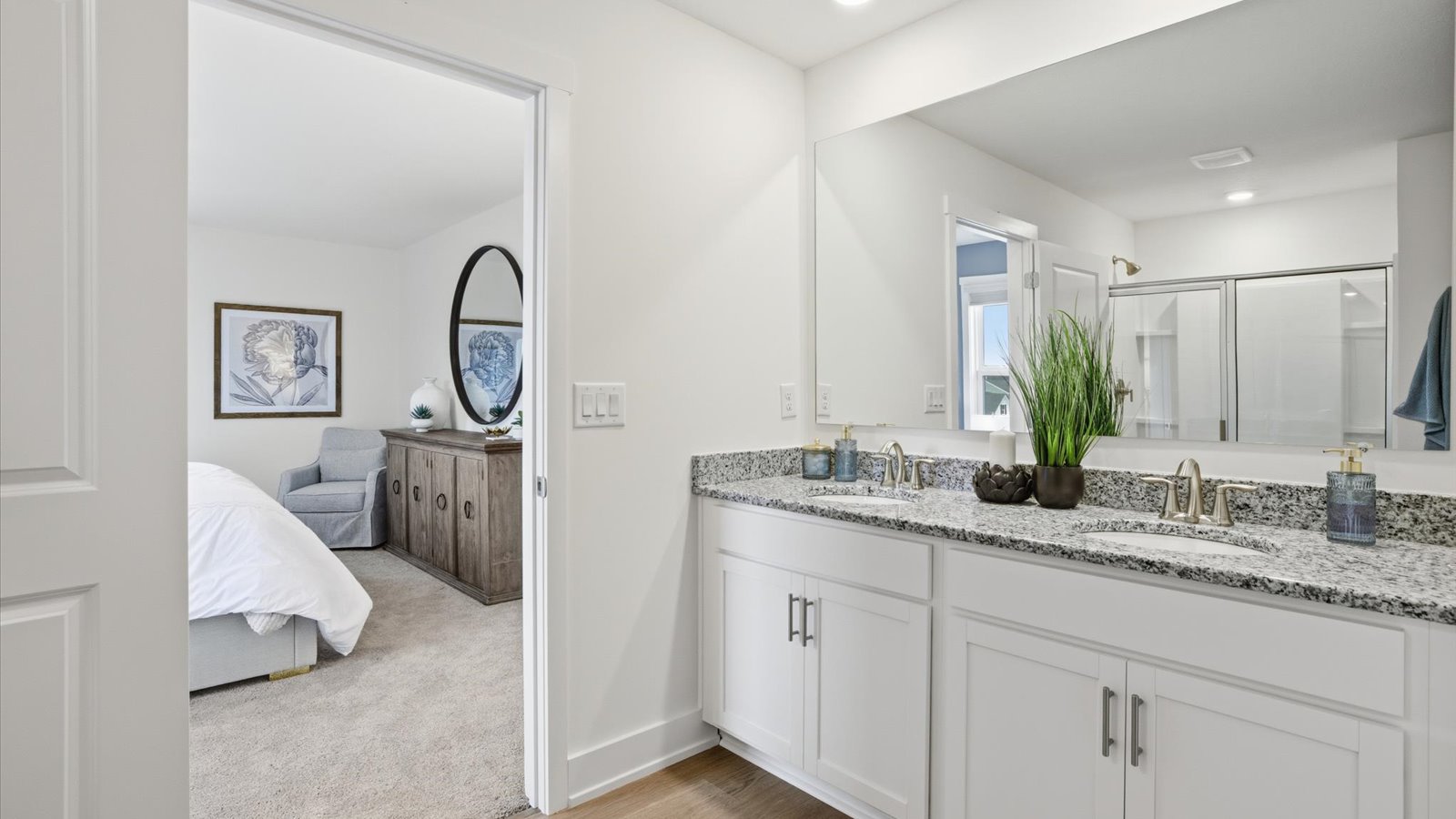 Primary bathroom with double vanity and walk-in shower