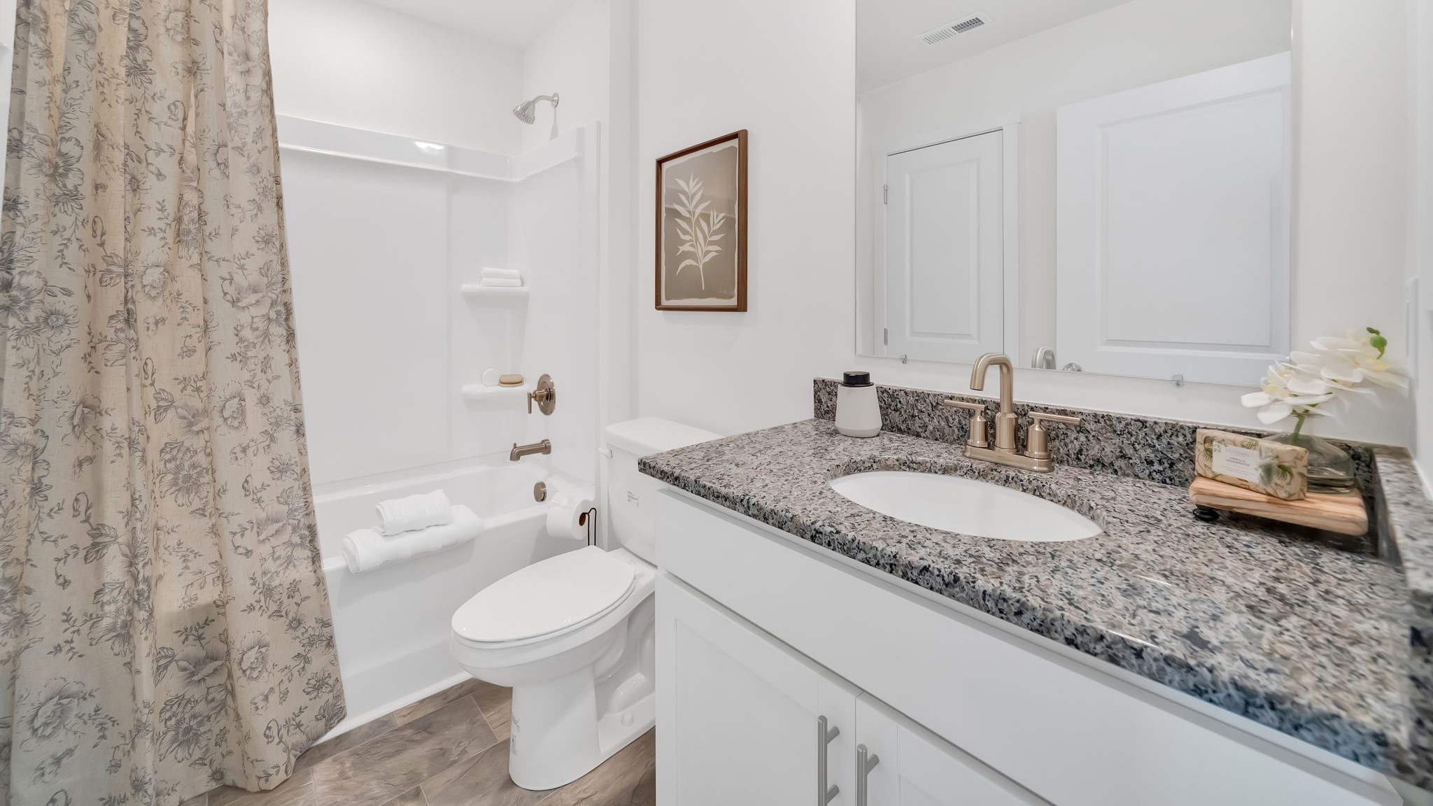 Guest bathroom with built in vanity and combination bathtub shower