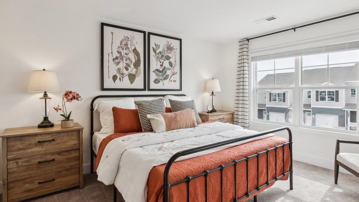 Primary bedroom with plush carpet floors and double light allowing windows