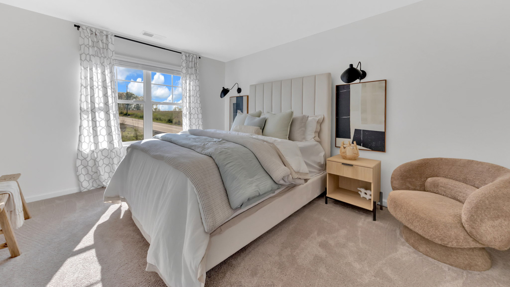 Primary bedroom with private attached bathroom and walk-in closet