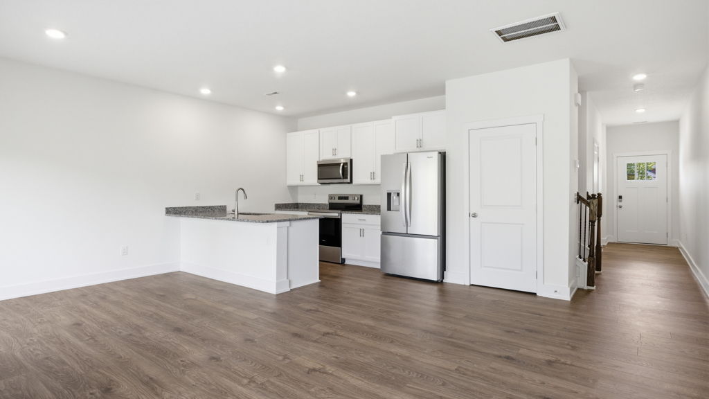 Open concept living, dining, and kitchen space