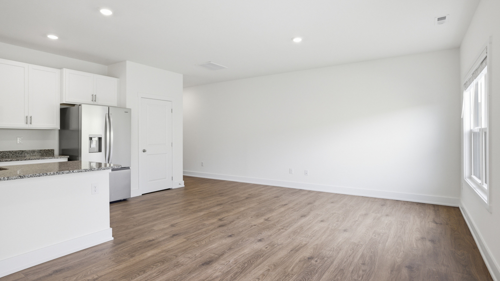 Open concept living, dining, and kitchen space