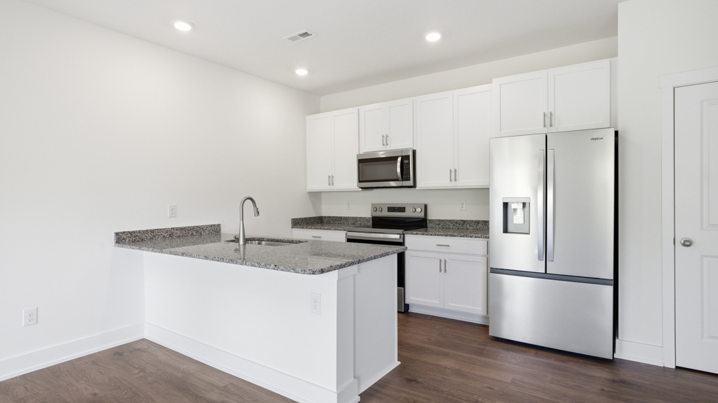 Spacious open concept kitchen with island and counter prep space