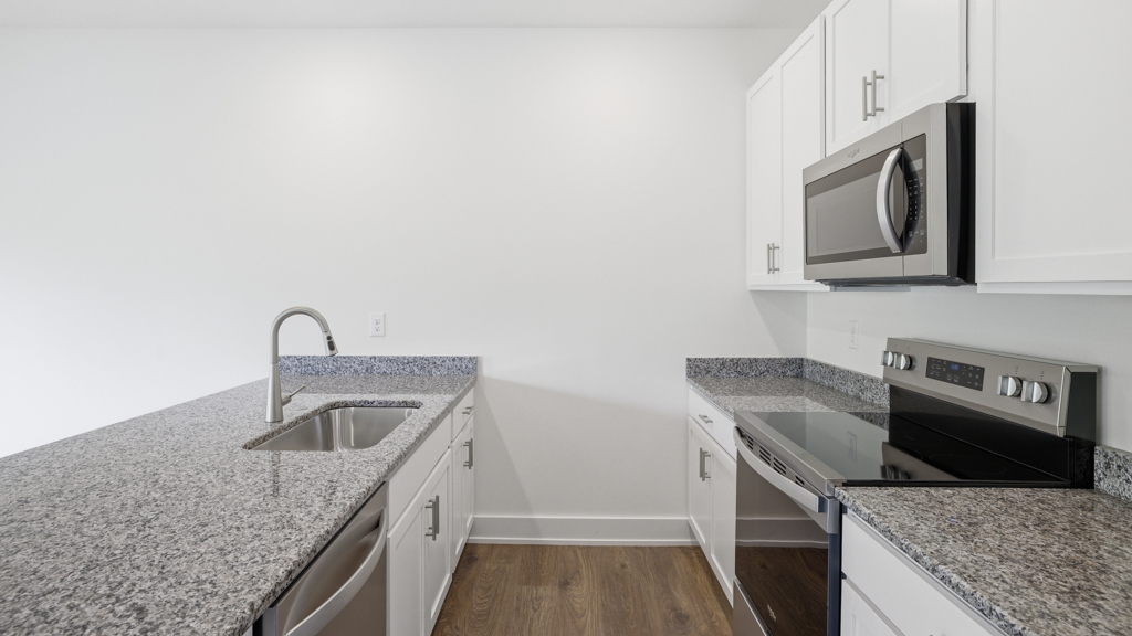 Kitchen with stainless steel appliances, shaker style cabinets, and elevated finishes