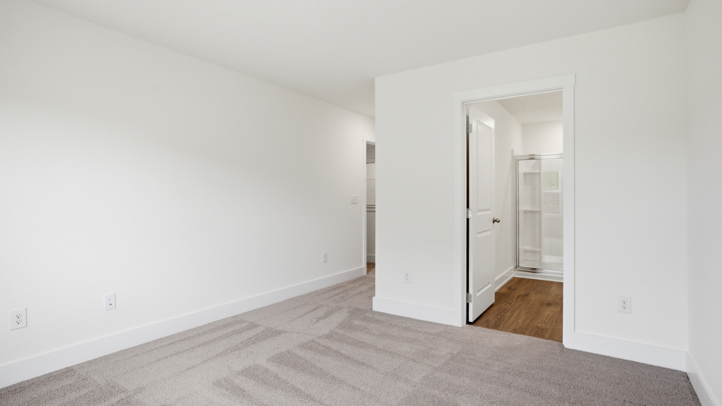 Primary bedroom with plush carpet floors and double light allowing windows