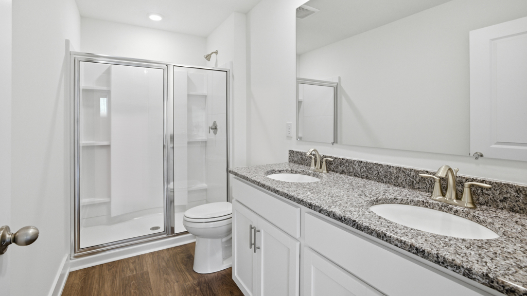 Primary bathroom with double vanity and walk-in shower