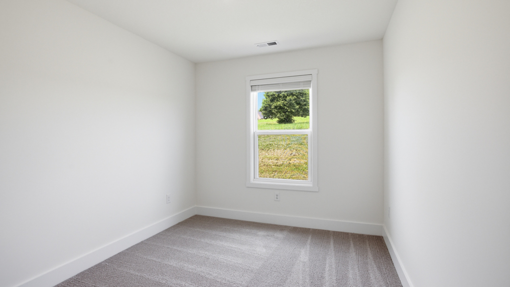 Bedroom with ample natural light and carpet floors