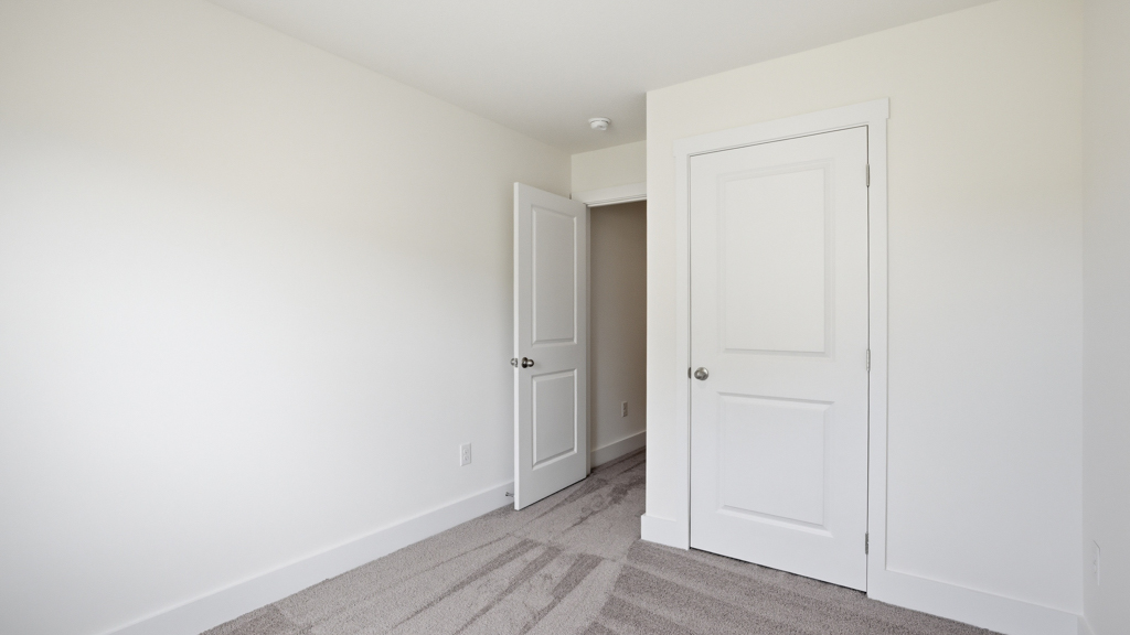 Bedroom with ample natural light and carpet floors