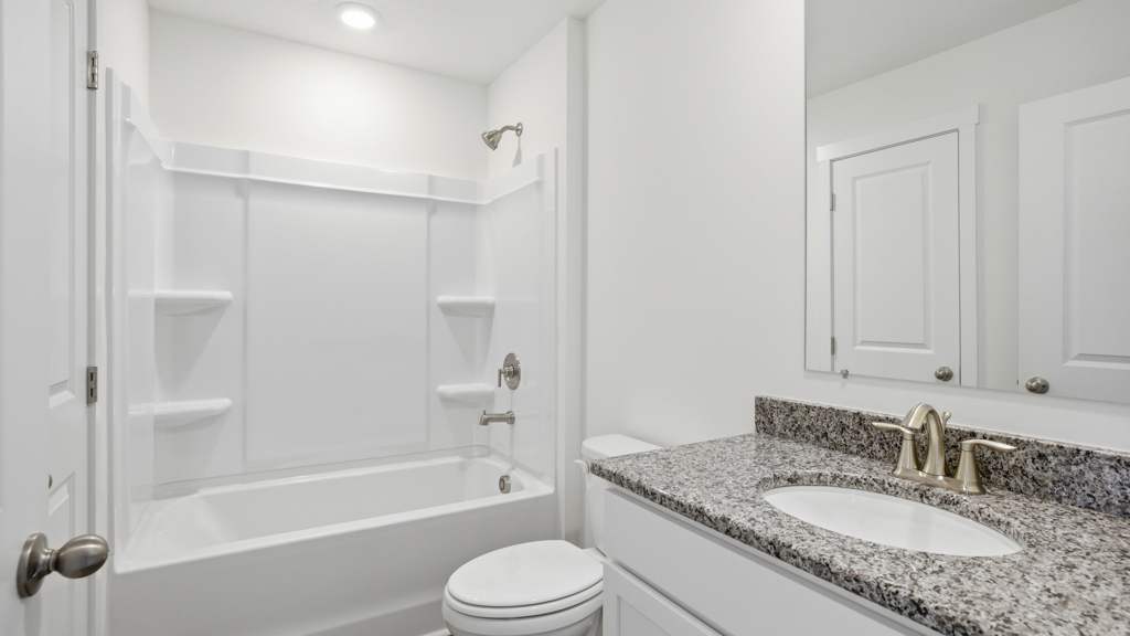 Guest bathroom with built in vanity and combination bathtub shower