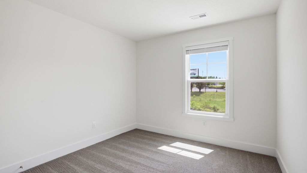 Bedroom with ample natural light and carpet floors