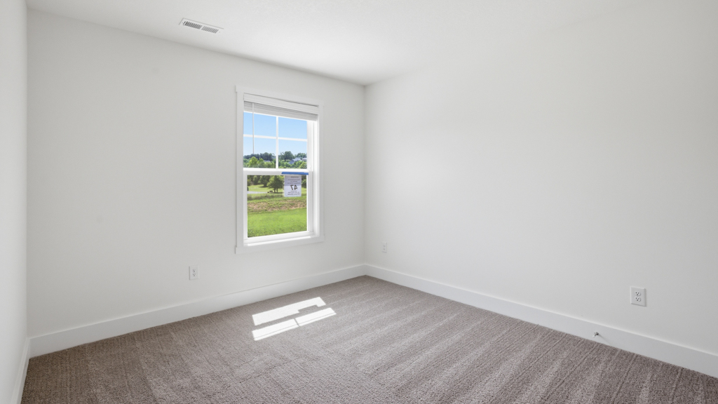 Bedroom with ample natural light and carpet floors
