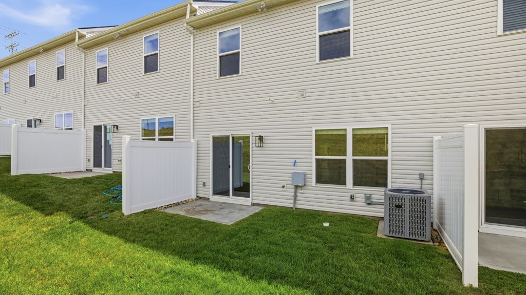 Rear exterior of home and landscaped sodded yard