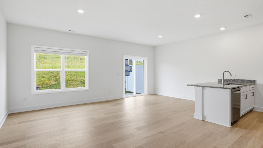Open concept living, dining, and kitchen space