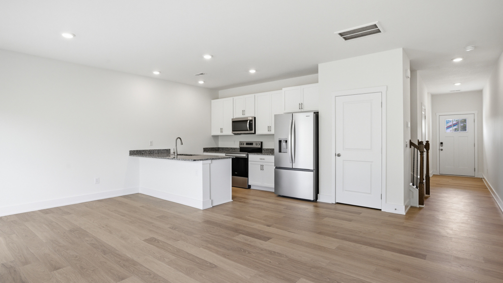 Open concept living, dining, and kitchen space