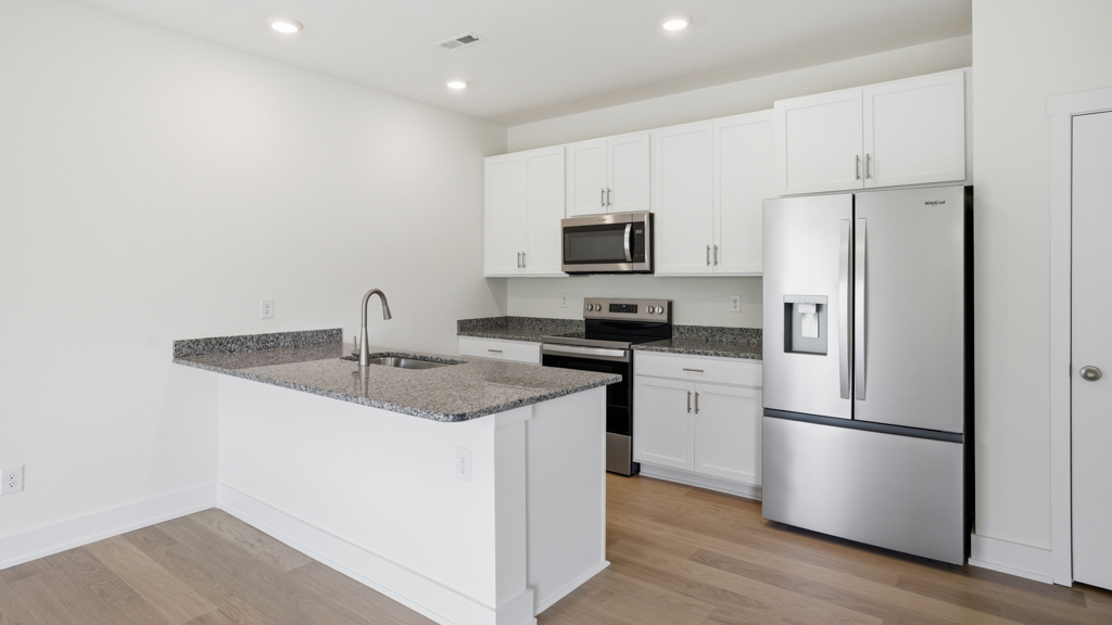 Open concept living, dining, and kitchen space