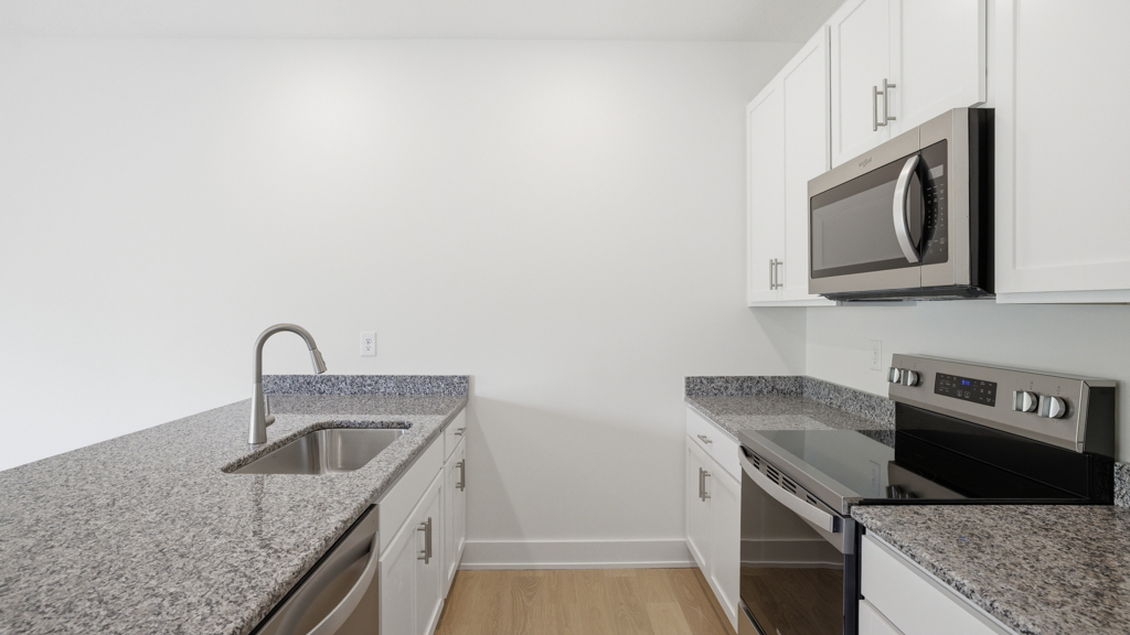 Kitchen with stainless steel appliances, shaker style cabinets, and elevated finishes