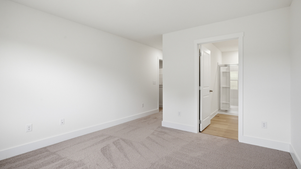 .Primary bedroom with plush carpet floors and double light allowing windows