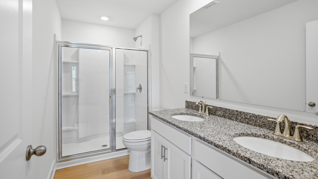 Primary bathroom with double vanity and walk-in shower
