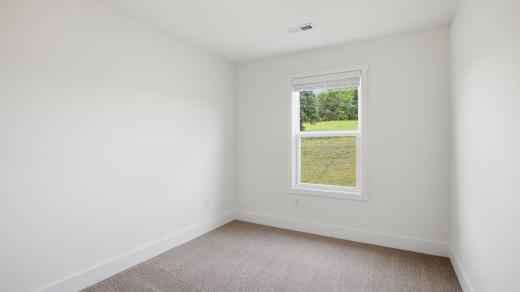 .Bedroom with ample natural light and carpet floors