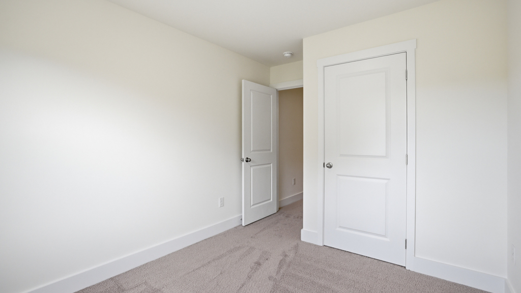 Bedroom with ample natural light and carpet floors