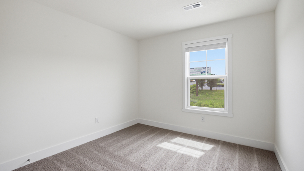 Bedroom with ample natural light and carpet floors