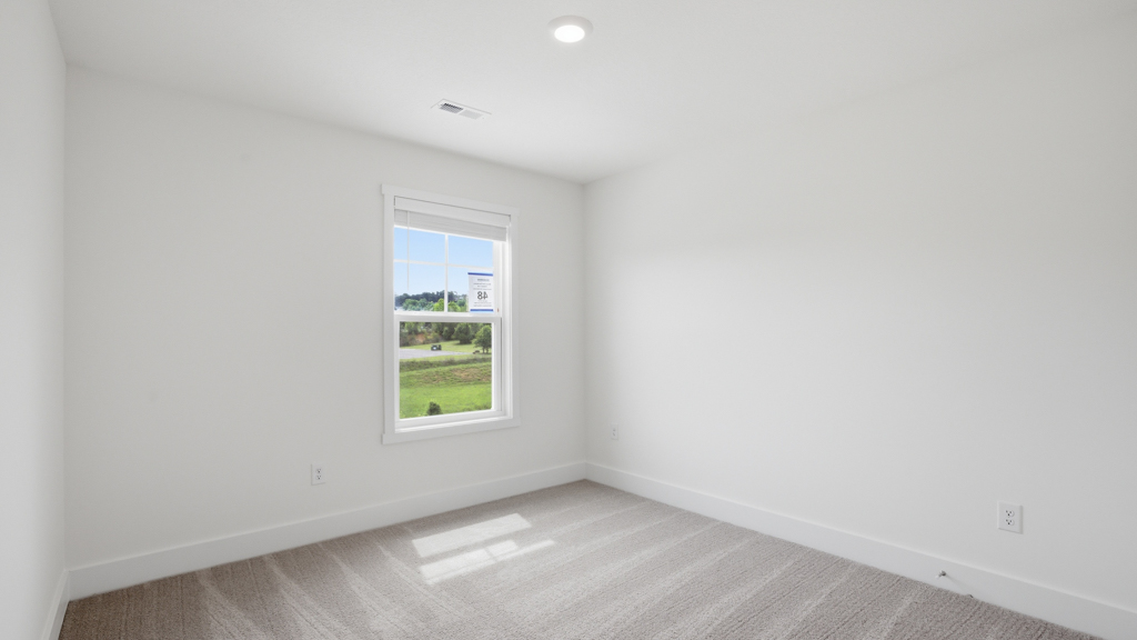 Bedroom with ample natural light and carpet floors