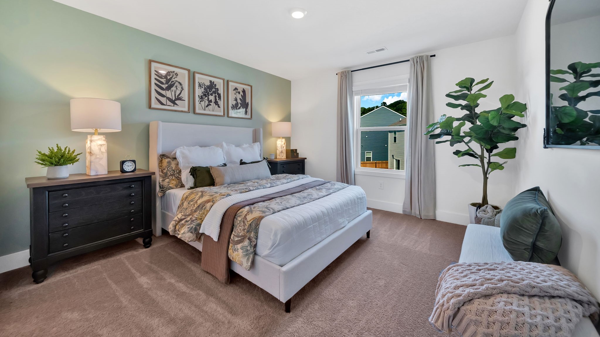 primary bedroom with carpet and large window for natural light