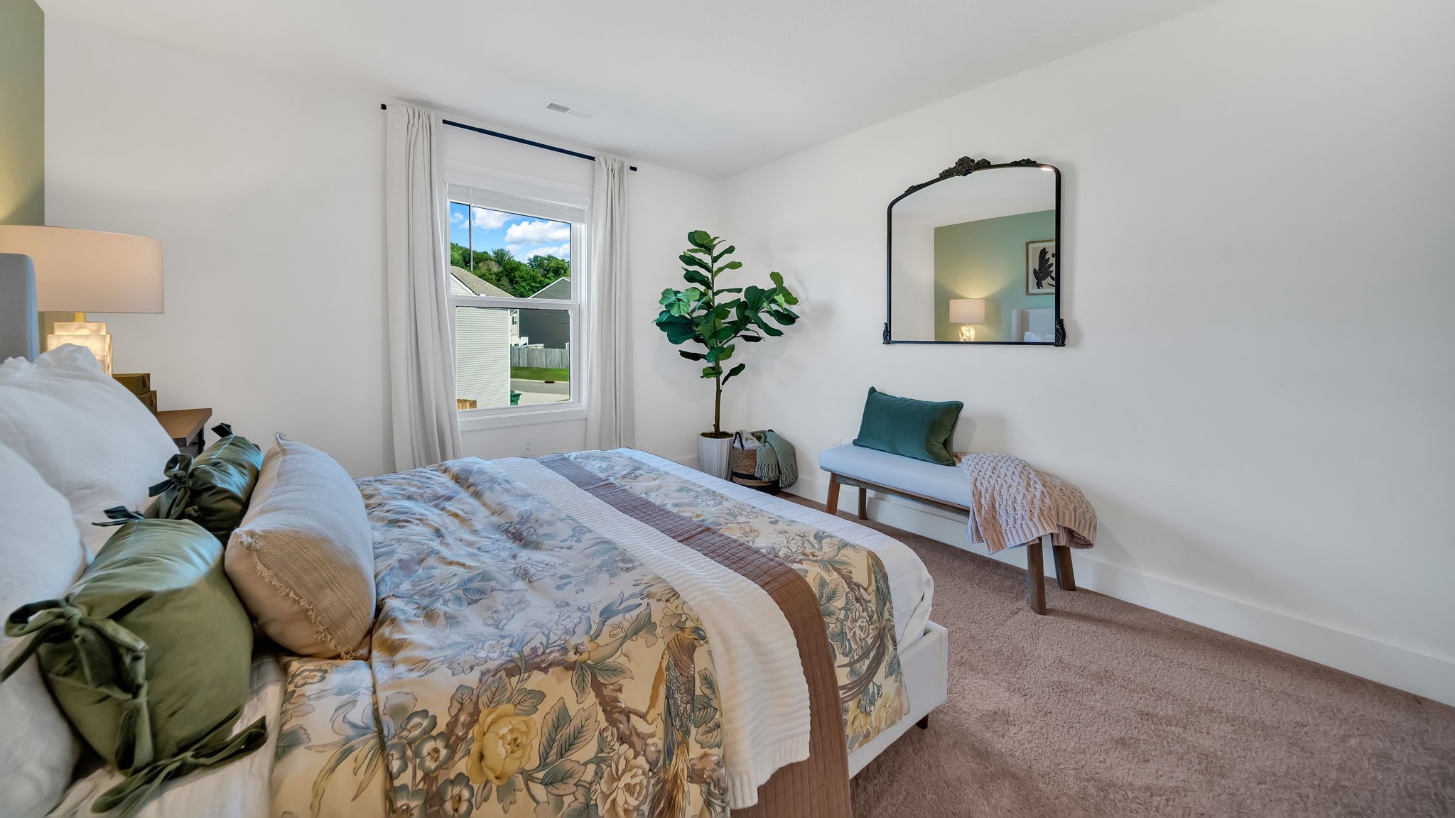 primary bedroom with carpet and large window for natural light